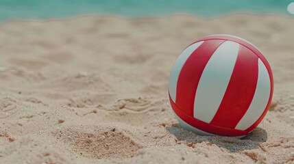 Obraz premium A white volleyball sits on white sand with a blue ocean in the background