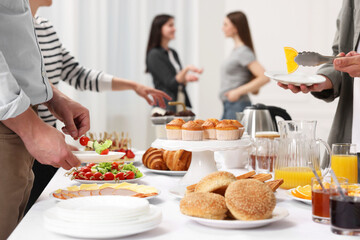 Coworkers having business lunch in restaurant, closeup