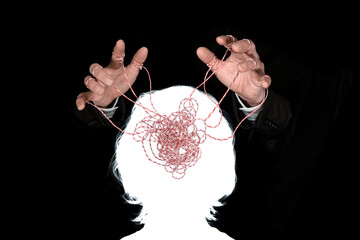Obeying master  hand pulling the strings in the silhouette of a human head. Concept of mental...