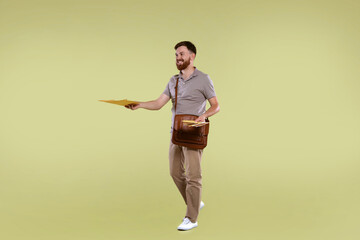 Postman with brown bag delivering letters on light green background