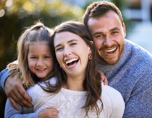 Laughing, parents and child in park for portrait or bonding together with funny joke, love or smile. Face, father or mother in outdoor nature for support, hug or security with girl, trust or family