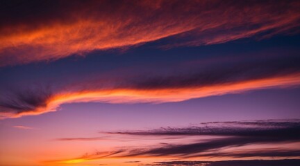 Fototapeta premium Sunset sky with a spectrum of colors ranging from deep purples and blues to warm oranges and pinks.