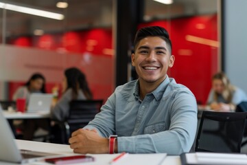 Young hispanic man smiling while working in busy office
