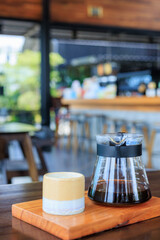 glass of coffee is poured into a glass carafe