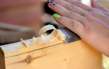 close up of a carpenter working on a wooden board
