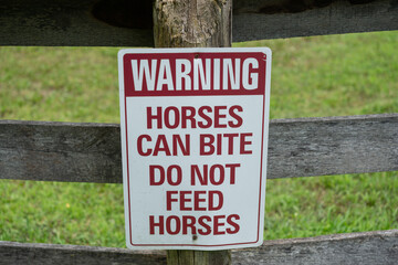 warning sign fixed to an old paddock wooden fencing