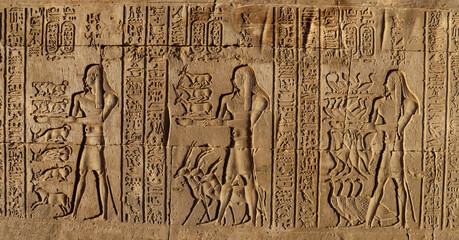 ancient egyptian hieroglyphs carved on stone wall, Kom ombo temple, Egypt