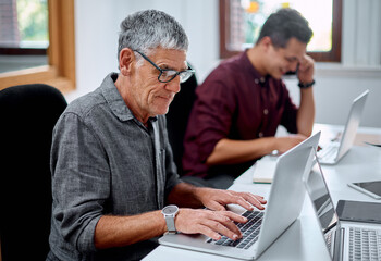 Laptop, typing and mature man in office for it support management report with online email....