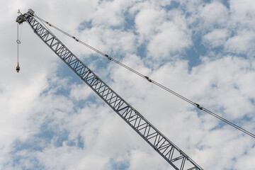 construction crane against cloudy blue sky