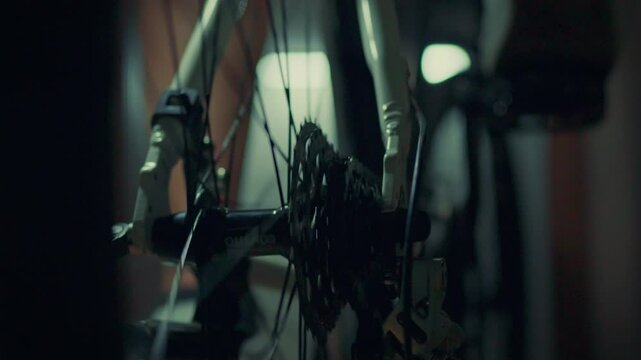 A professional cycling athlete trains by pedaling against resistance in a special gym to improve his performance. Leadership and motivation as a lifestyle. Cycling and sporting achievements