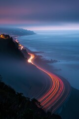 Highway 1 winding through foggy california coastline at dusk