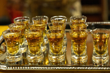 Strong alcoholic drink in small glasses.