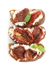 Delicious ricotta bruschettas with sun dried tomatoes and basil isolated on white, top view