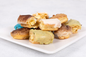 Assorted Eclairs in Vibrant Colors: A Delightful and Colorful Pastry Display