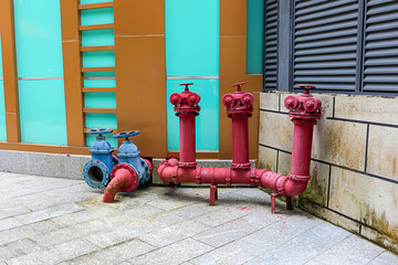 A red fire hydrant is installed on the building.