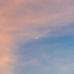 Clouds turn pink in the sky at sunset
