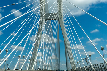 Obraz premium Beautiful suspension bridge under a bright blue sky with white clouds. Wroclaw. Poland. High quality photo