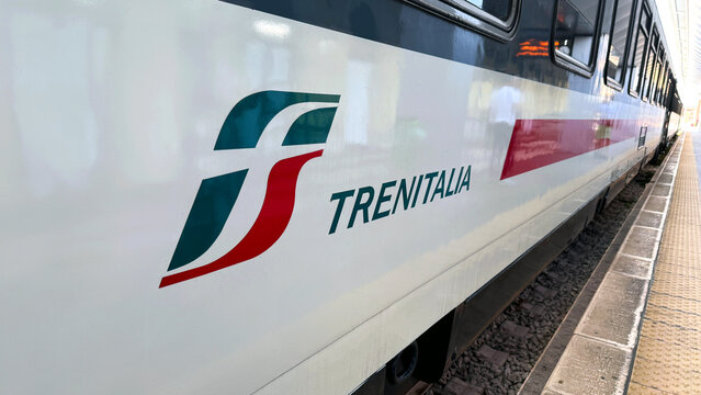 Side view of a Trenitalia train in an Italian railway station