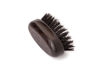 Close up view of a black wood beard brush with natural bristles on a white background in the center...