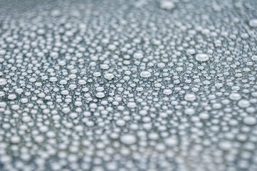 Water droplets on clear dark glass background