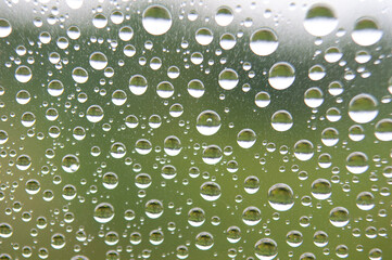 Water droplets after rainy day with dark background. Image suitable for laptop wallpaper or any design background.