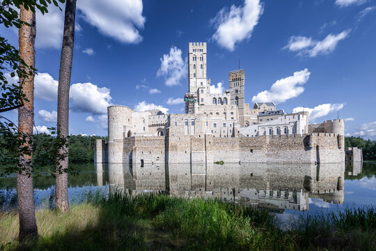 STOBNICA, POLAND - JULY 19, 2024. Famous, picturesque Stobnica Castle, built in the style of a large medieval fortress and located beautifully by the lake in the middle of the forest.
