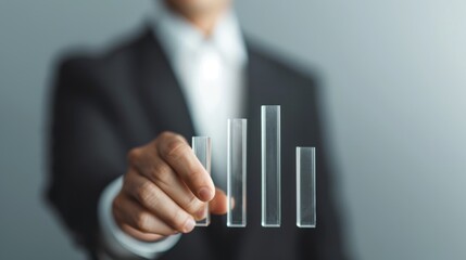 Businessman Adjusting Transparent Bar Graph for Clarity and Progress on Light Grey Background with Space for Text.