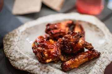 Glazed chicken wings on white plate