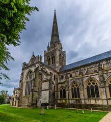 Obraz premium A view along the side of Chichester Cathedral in the center of Chichester, Sussex in summertime