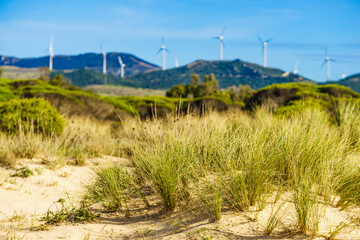 Sand dune and wind turbines on hill, Andalusia Spain