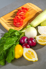 A wooden cutting board with freshly sliced tomatoes displayed on top