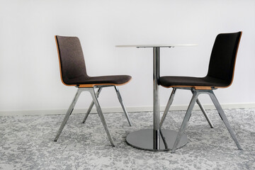 Two chairs and a table in an office room