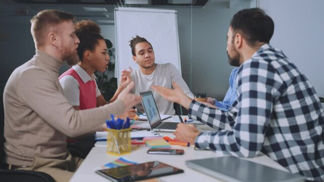Leader watches team members engage in heated debate during office meeting. Facial expressions and hand gestures indicate intense discussion and differing opinions. Concept of leadership and conflict