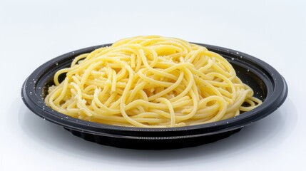 Delicious spaghetti served on a black plate.