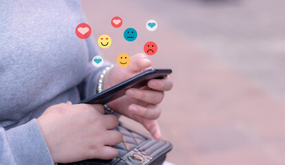 Young woman using smart phone mobile with, Social Media and Emoji express the emotions