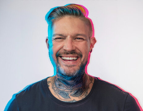 Vibrant Glitch Art of Tattooed Man Giggling in Studio with High-Contrast Effects
