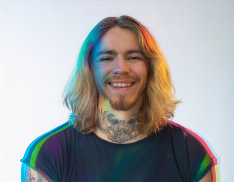 Vibrant Glitch Art of Tattooed Man Giggling in Studio with High-Contrast Effects