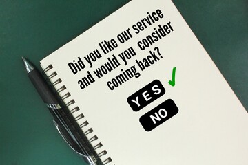 pen and book with questions Did you like our service, and would you consider coming back? answer yes Customer service concept.