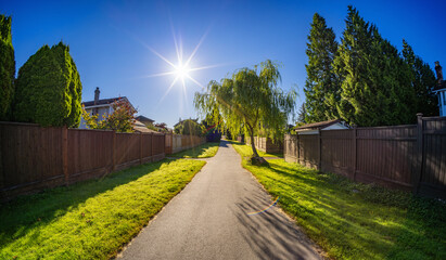 Walking Path by Residential Homes in a suburban city street sunny morning. Surrey, Vancouver, BC, Canada