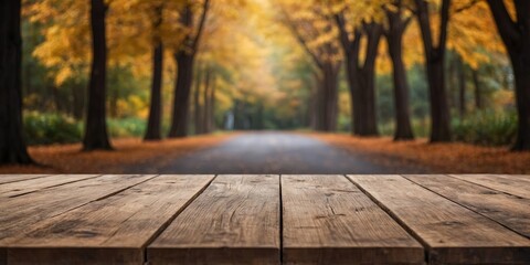 Empty wooden table space with autumn blur backround.