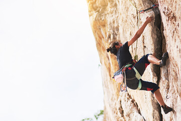 Rock climbing, rock and woman in nature for sport, mountain and adventure on cliff. Rope, explore or safety with harness and equipment for female person, hobby and challenge on boulder mockup