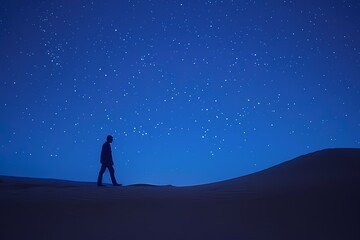 Fototapeta premium Silhouette of a Man Walking Alone Under a Starry Night Sky.