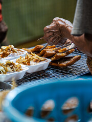 Street Food Vendor Serving Deep Fried Snacks