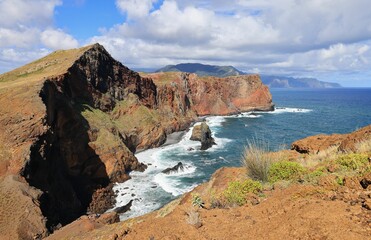 cliffs surrounded by the sea under cloudy sky in Vereda da Ponta de Sao Lourenco, Madeira, Portugal