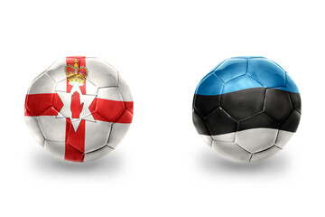 Obraz premium football balls with national flags of estonia and northern ireland , soccer teams. on the white background.