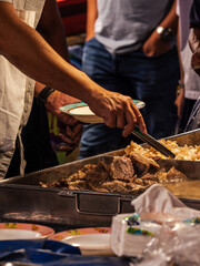 Person Serving Food at a Street Market