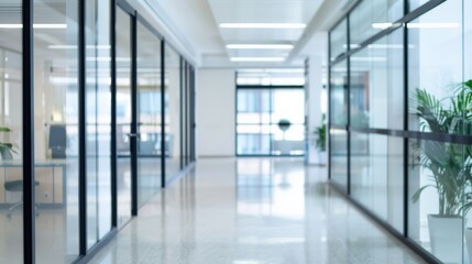 Modern office corridor with glass partitions and blurred background, professional and contemporary corporate environment.