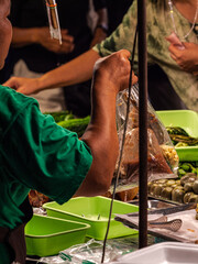 Vendor Filling Bag With Food at Market Stall