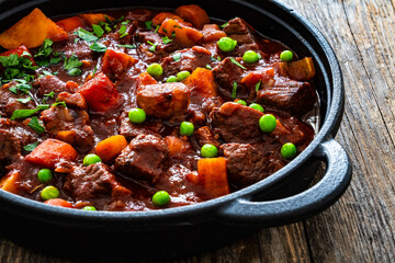 Irish stew for St. Patrick's Day - roast beef in beer with vegetables served in frying pan on...