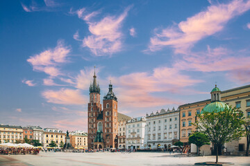 Naklejka premium Krakow, Poland. St. Mary's Basilica And Cloth Hall Building. Famous Old Landmark Church Of Our Lady Assumed Into Heaven. Saint Mary's Church In Of The Main Market Square. UNESCO World Heritage Site